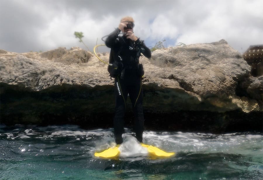 Taking a giant stride into the water at Oil Slick Leap in Bonaire.